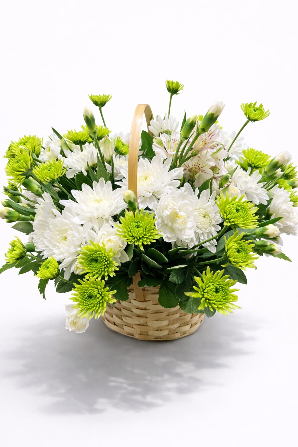Basket of white and lime-green chrysanthemums with a handle