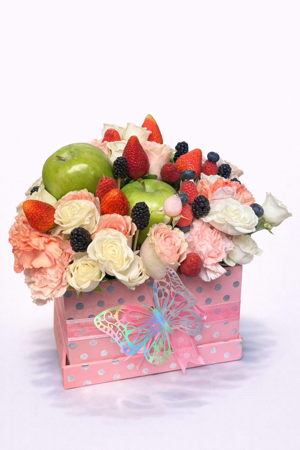 Fruit and flower arrangement in a pink gift box with a butterfly ribbon