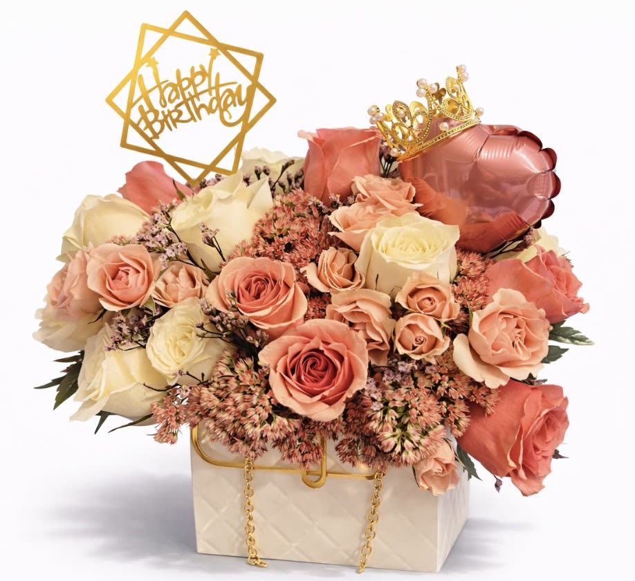 Peach and cream roses in a gift box with a birthday topper and crown