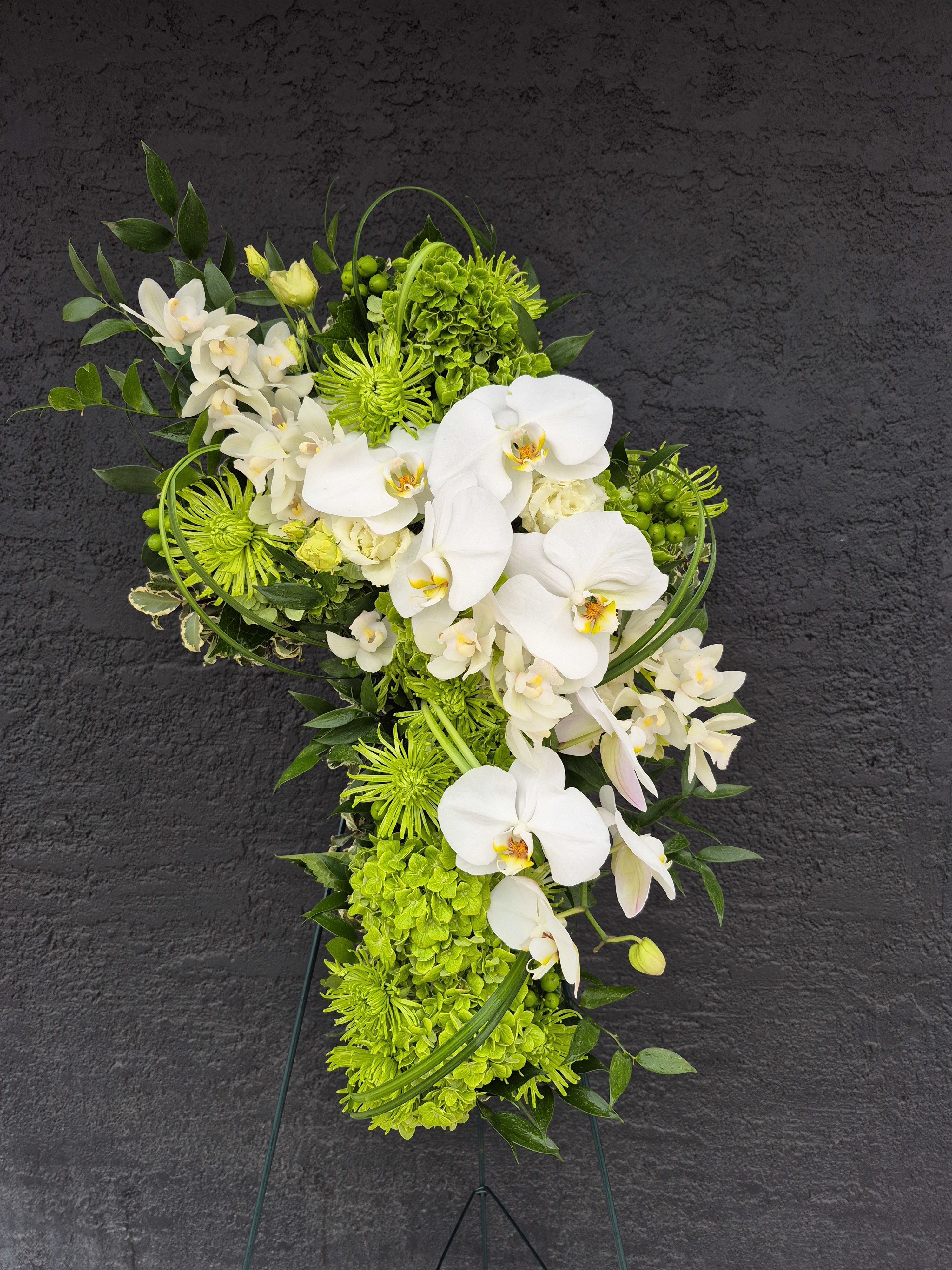 Green and white floral standing spray with orchids and chrysanthemums