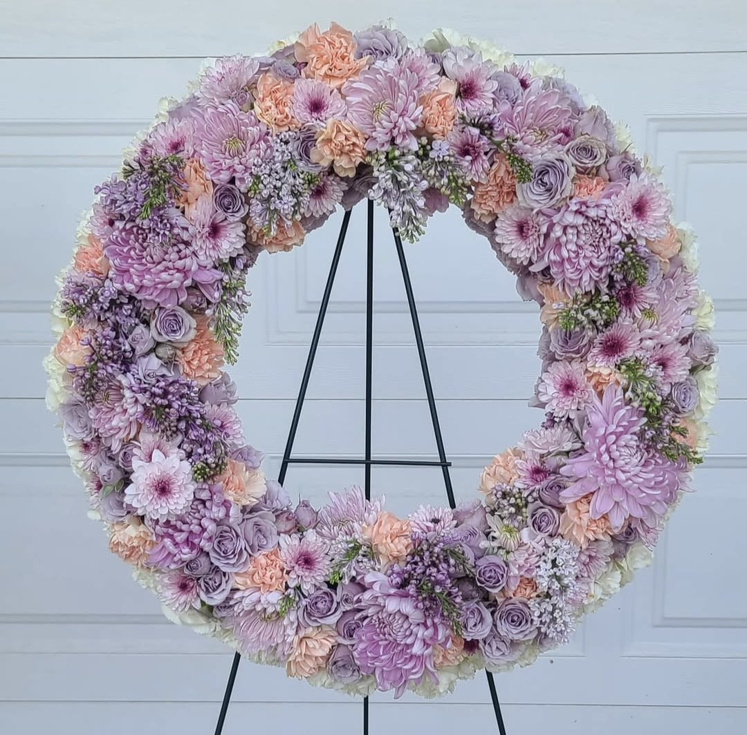 Large pastel floral wreath on a black stand