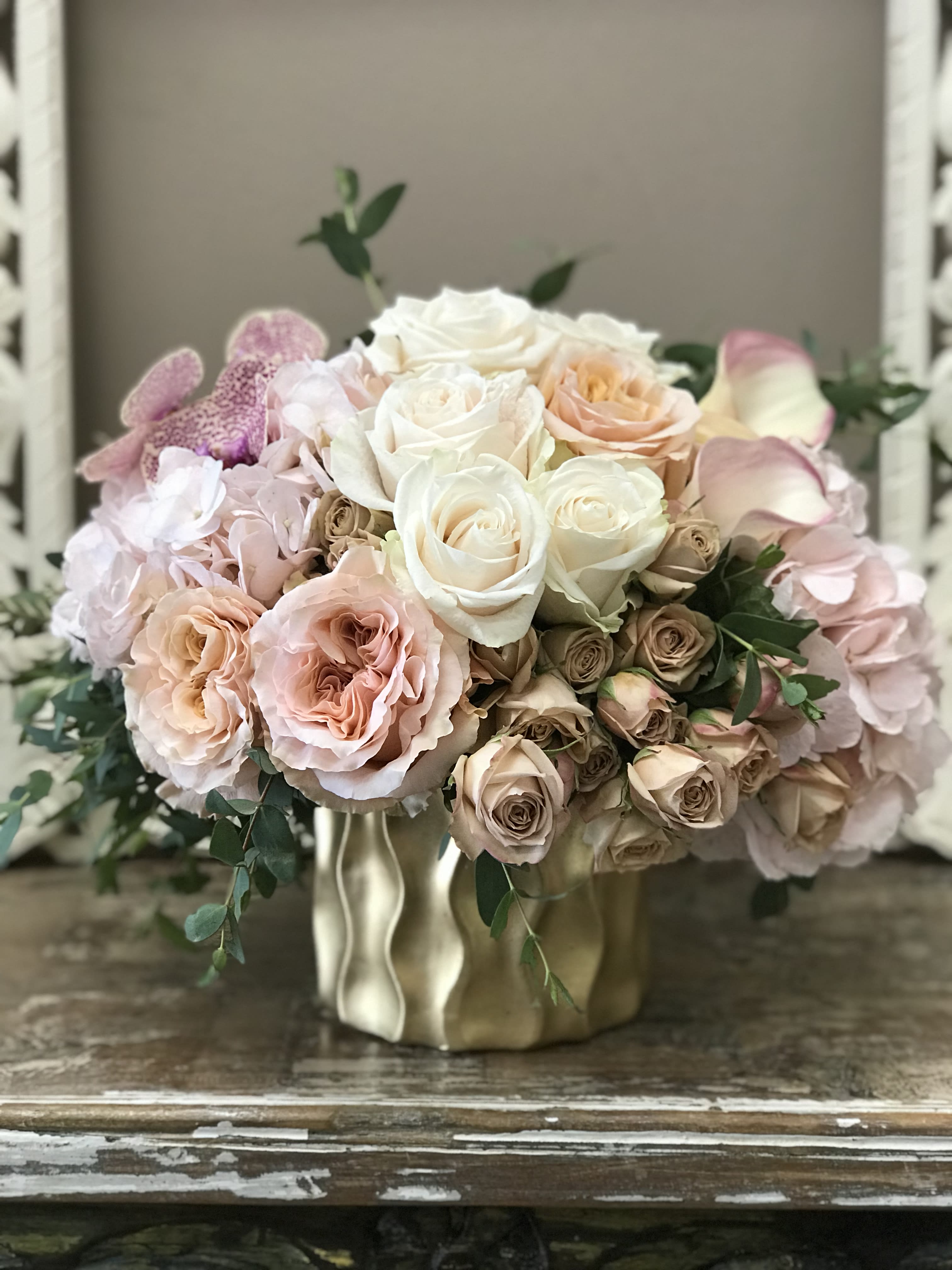 Blush and white rose bouquet in a gold vase