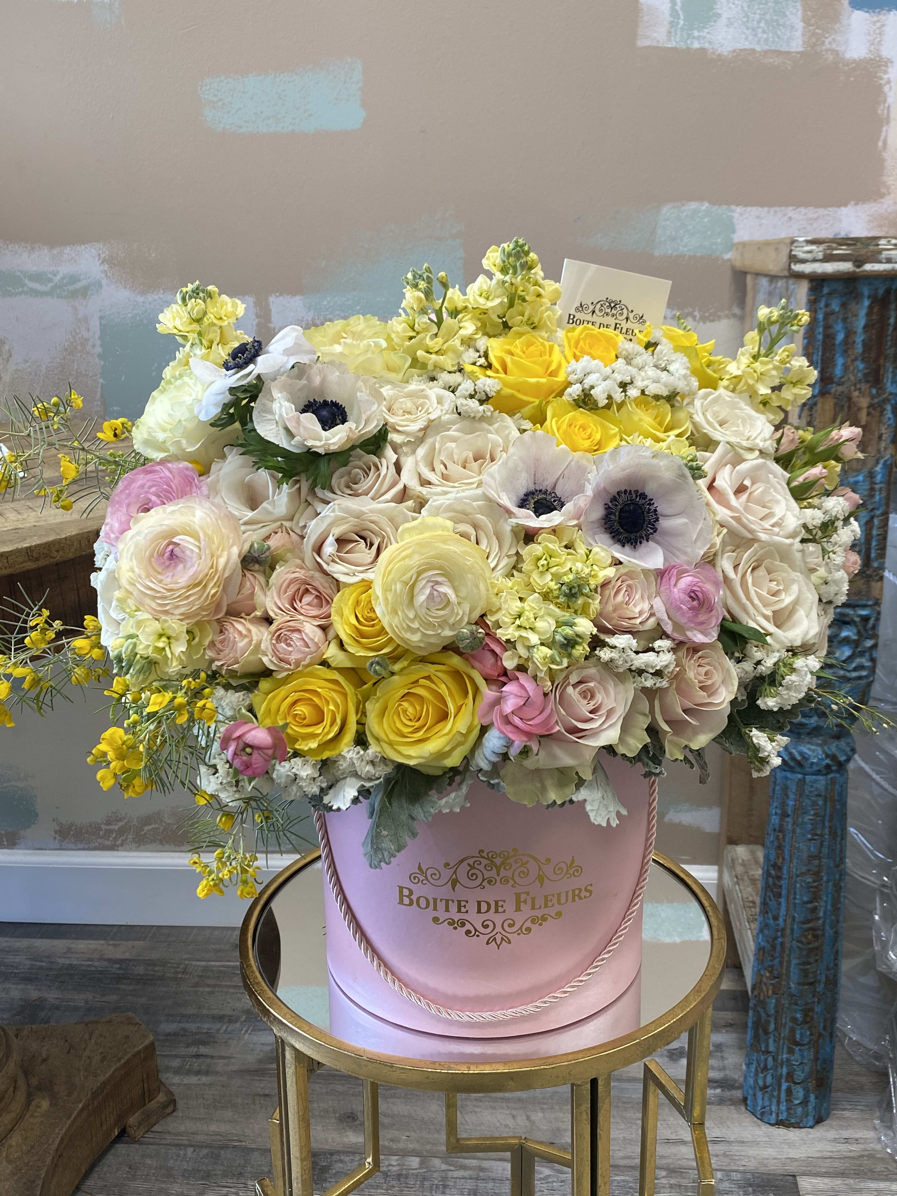 Large pastel flower arrangement in a pink hatbox
