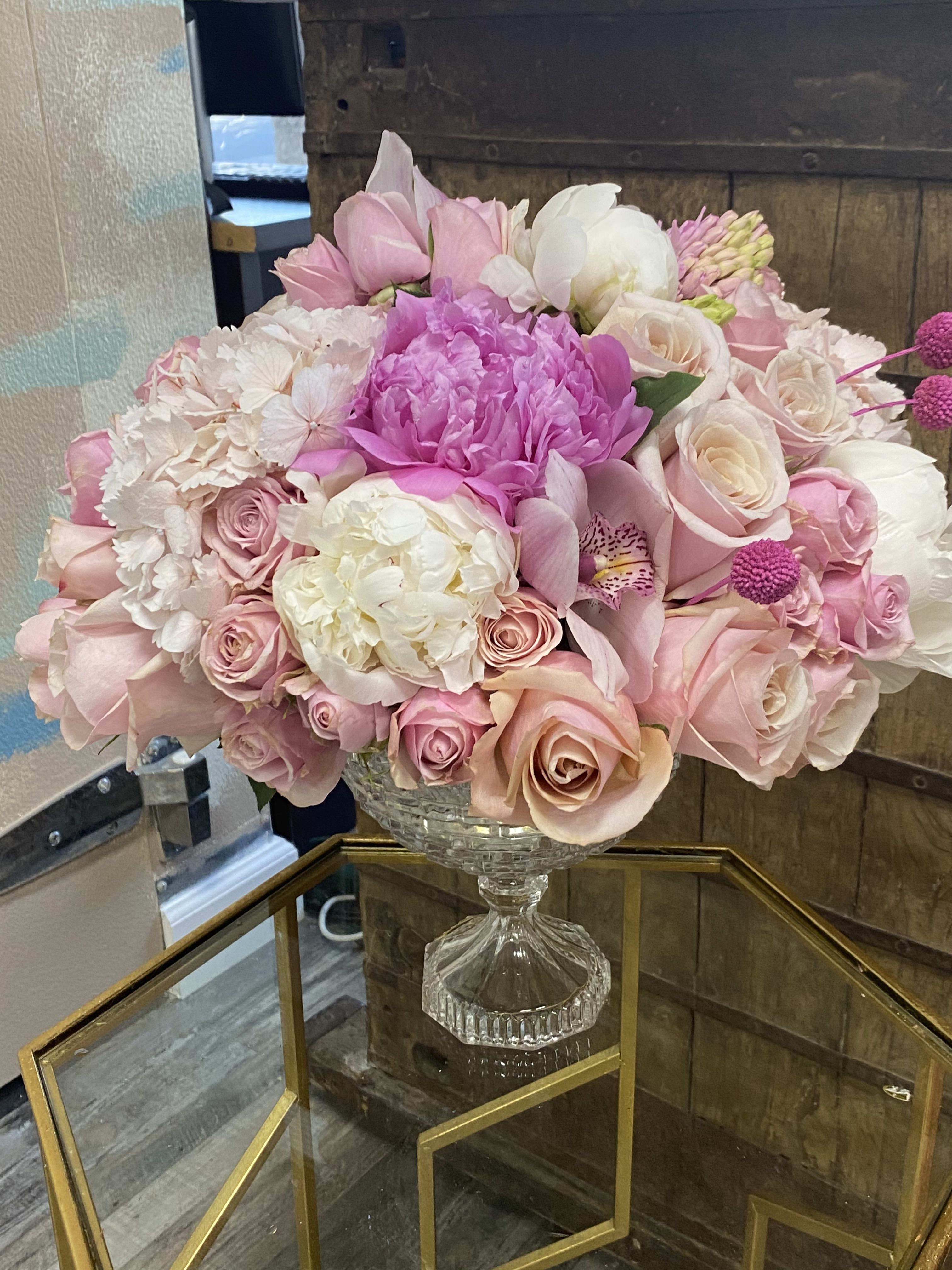 Pink and white floral arrangement in a clear glass vase