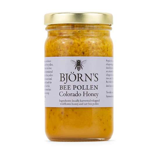 Jar of bee pollen honey with a gold lid and label