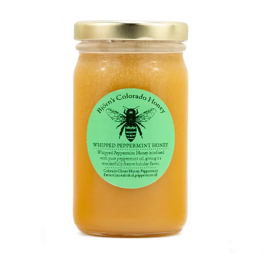 Jar of whipped peppermint honey with a gold lid and green label
