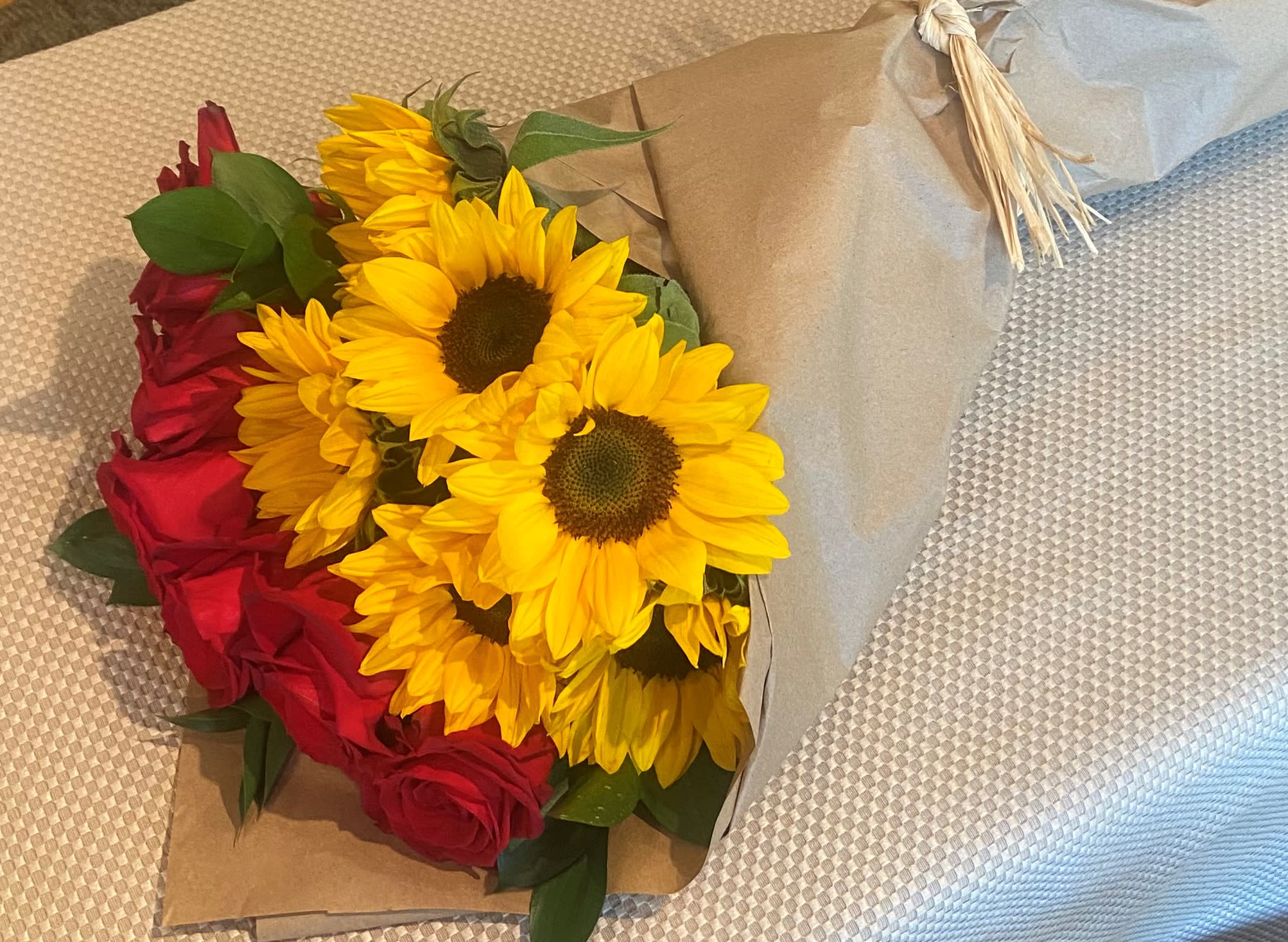 Sunshine &amp; Roses - 6 exquisite long stem red roses coupled with 6 striking medium sunflowers, accented with Israeli Ruscus all wrapped in trendy craft paper surround accented by a coordinating ribbon....a truly wonderful expression of fall!