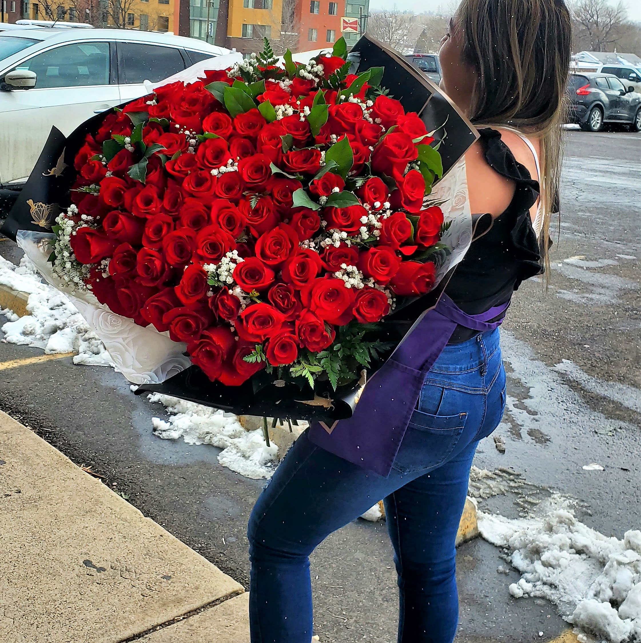 Large bouquet of red roses wrapped in black paper