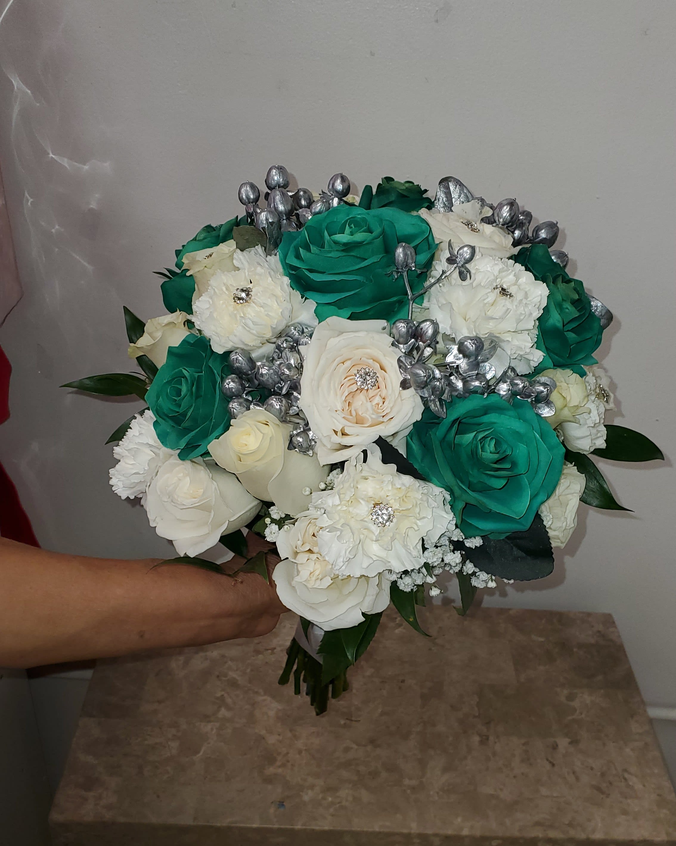 Bouquet of teal and white roses with silver accents