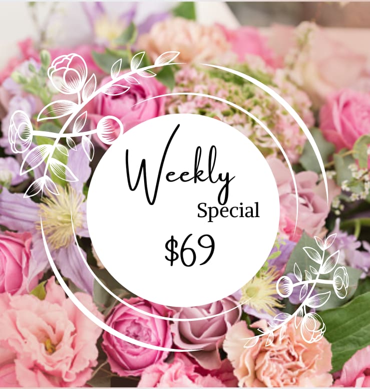 Pink and lavender flower bouquet with a "Weekly Special $69" sign