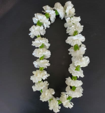 White flower lei on a dark background