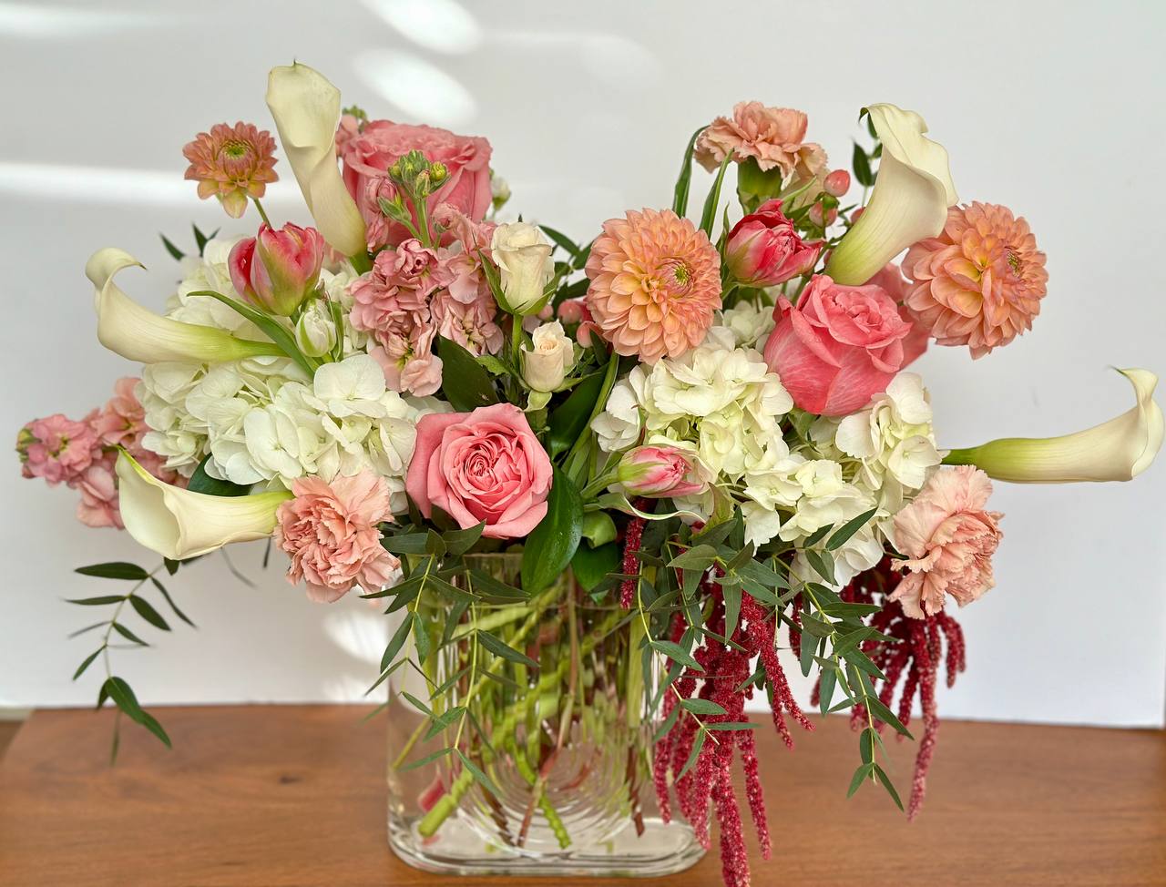 Pink and white mixed bouquet in a clear glass vase
