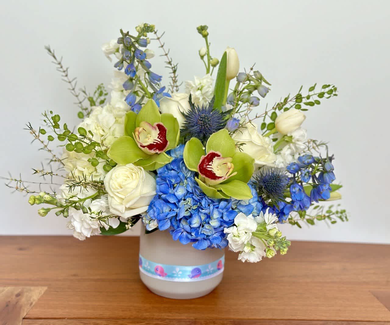 Blue and white floral arrangement in a gray vase