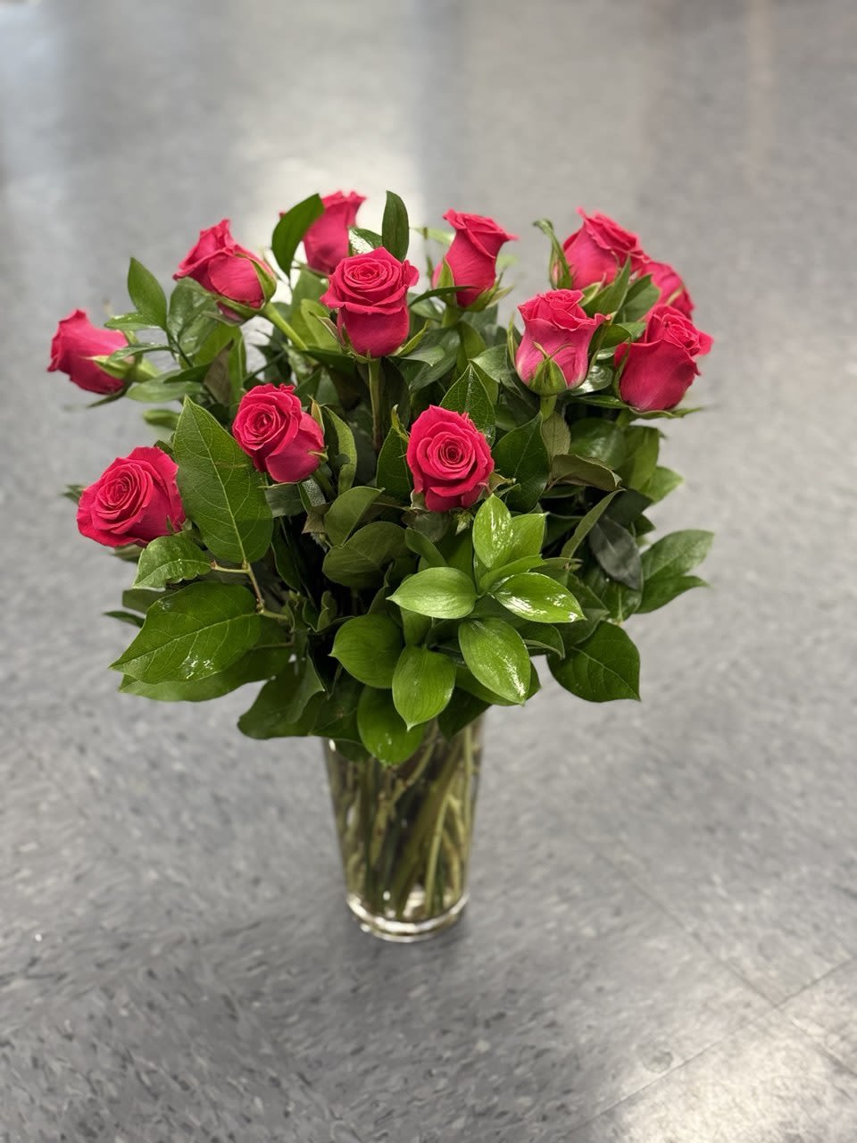 Pink roses arranged in a clear glass vase