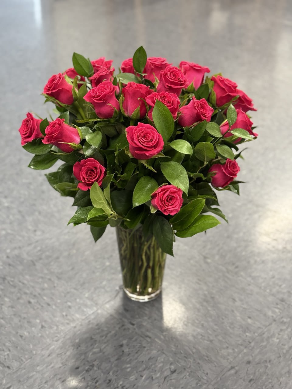Bouquet of hot pink roses in a clear glass vase