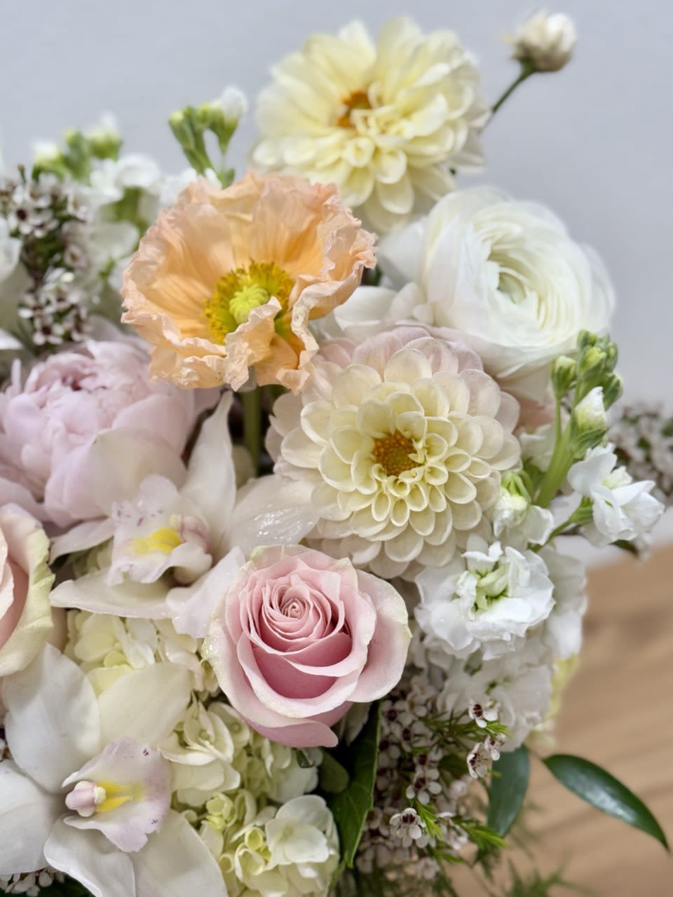 Pastel bouquet with pink roses, cream dahlias, and white blooms