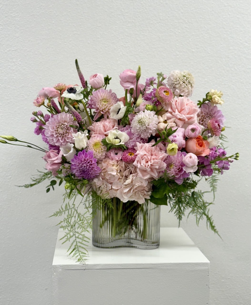 Pink and lavender mixed bouquet in a clear glass vase