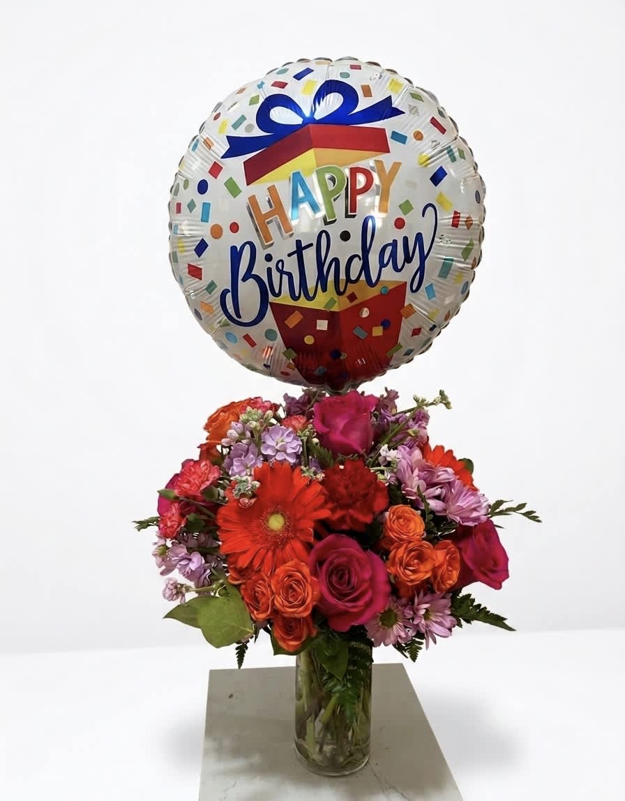 Birthday balloon above a colorful bouquet in a glass vase