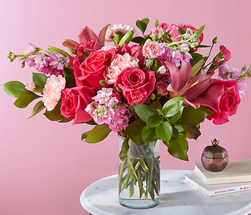 Pink rose bouquet in a clear glass vase on a table
