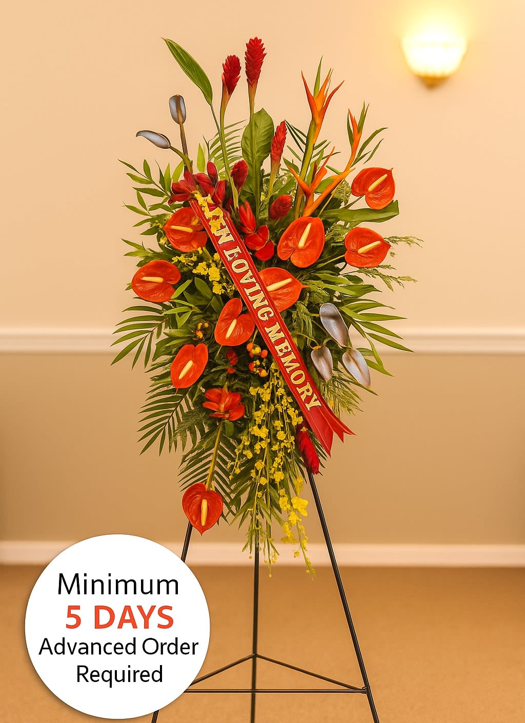 Tall tropical sympathy standing spray with red-orange flowers on an easel