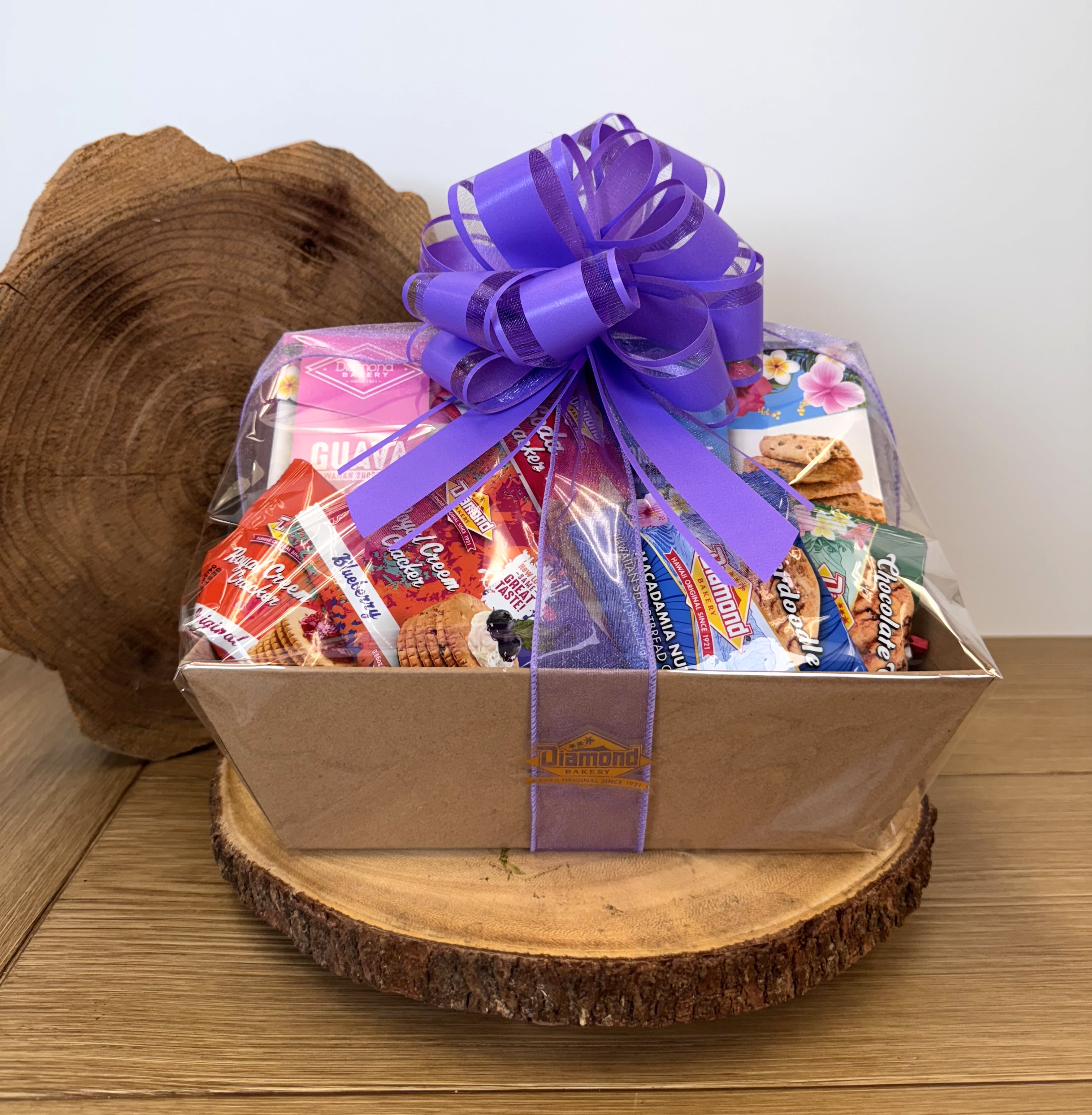 New Item! Diamond Bakery Gift Set (Medium) - Diamond Bakery Snack Basket – A Taste of Hawaiʻi in Every Bite   Bring the flavors of the islands to your home or share aloha with loved ones through our Diamond Bakery Snack Basket, featuring Hawaiʻi’s most famous legacy food brand. Filled with beloved local Diamond Bakery favorites, these baskets are available in three convenient sizes and make the perfect gift for any occasion.  Why Choose Our Diamond Bakery Snack Basket?   Three Sizes Available: Choose from Small, Medium, or Large to fit any celebration or gifting need.   Packed with Local Favorites: Each basket is brimming with Diamond Bakery classics—Hawaiian cookies, crackers, and more island-inspired snacks.   A Legacy Brand Since 1921: Diamond Bakery has been Hawaiʻi’s trusted name in snacks for over 100 years.   Perfect for Any Occasion: From birthdays to thank-you gifts, corporate events to holiday celebrations, this basket shares the spirit of aloha.   Locally Made in Hawaiʻi: Support a Hawaiian-owned company while enjoying the authentic taste of the islands.  Who This Basket Is For Friends or family, or treat employees to a corporate thank-you gift, or stock your home with local flavors, our Diamond Bakery Snack Basket is the perfect choice.  Delivery &amp; Availability   Available for local delivery across Oʻahu   Freshly packed to ensure the best taste experience