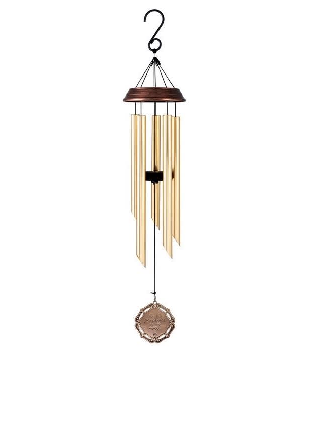 Hanging metal wind chime with gold tubes and a decorative medallion