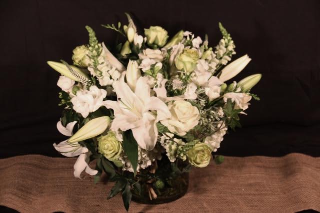 White Mix - White seasonal flowers arranged in a glass cube