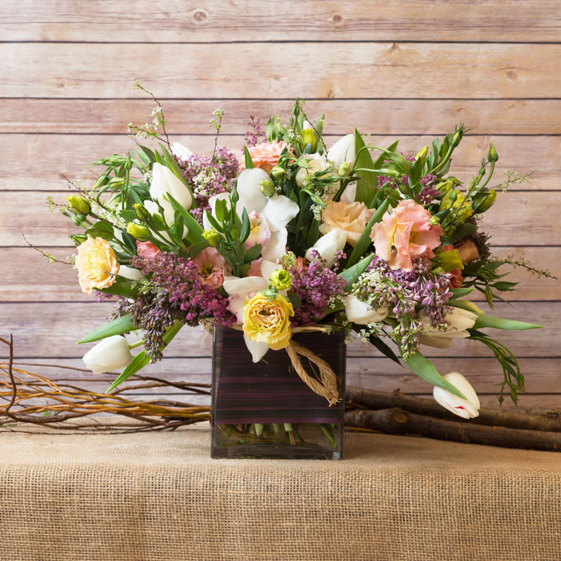 WILD GARDEN ARRANGEMENT  - Tap into your inner gardener with this lush arrangement of white tulips, cymbidium orchids, lilacs, lisianthus.