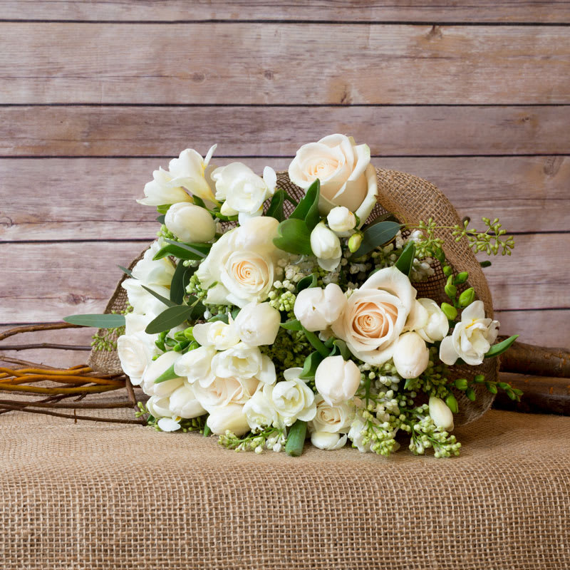 BECAUSE I CAN BOUQUET  - BEAUTIFUL CLASSIC ASSORTMENT OF WHITE ROSES, WHITE FREESIA, WHITE LILAC, WHITE TULIPS WRAPPED IN RUSTIC BURLAP.