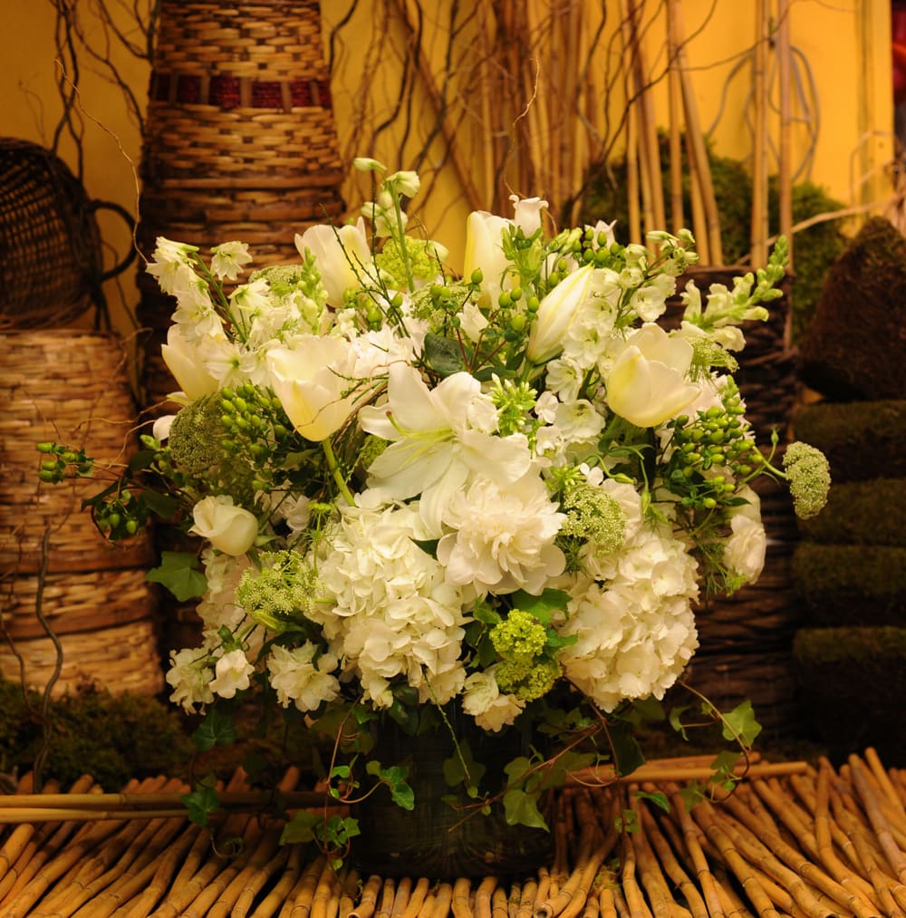 BONJOUR - ELEGANT AND CLASSY FRENCH INSPIRED ARRANGEMENT WITH WHITE PEONIES, WHITE FRENCH TULIPS, WHITE HYDRANGEA, WHITE LARKSPUR, WHITE CASABLANCA LILIES, WHITE ROSES, WHITE PHLOX, WHITE SNAPDRAGON, IVY, WILD CARROT, WHITE DELPHINIUM, WHITE AZALEA AND GREEN HYPERICUM. 