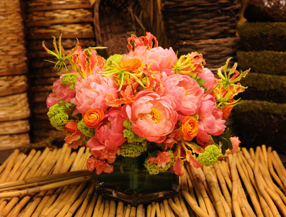 Pink and orange floral arrangement in a glass vase