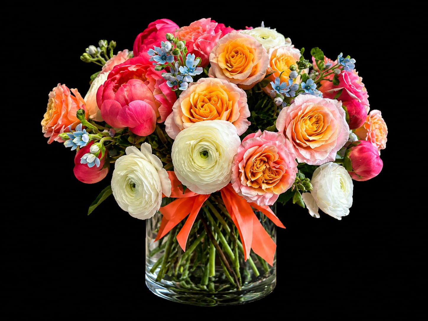 Coral Sunset Garden - Each arrangement is handcrafted by Flowers by Philip using the freshest seasonal flowers available. Because every design is made by hand, slight variations may occur, ensuring each arrangement is truly one of a kind.  A show-stopping floral design that captures the beauty of a blooming spring garden with timeless elegance