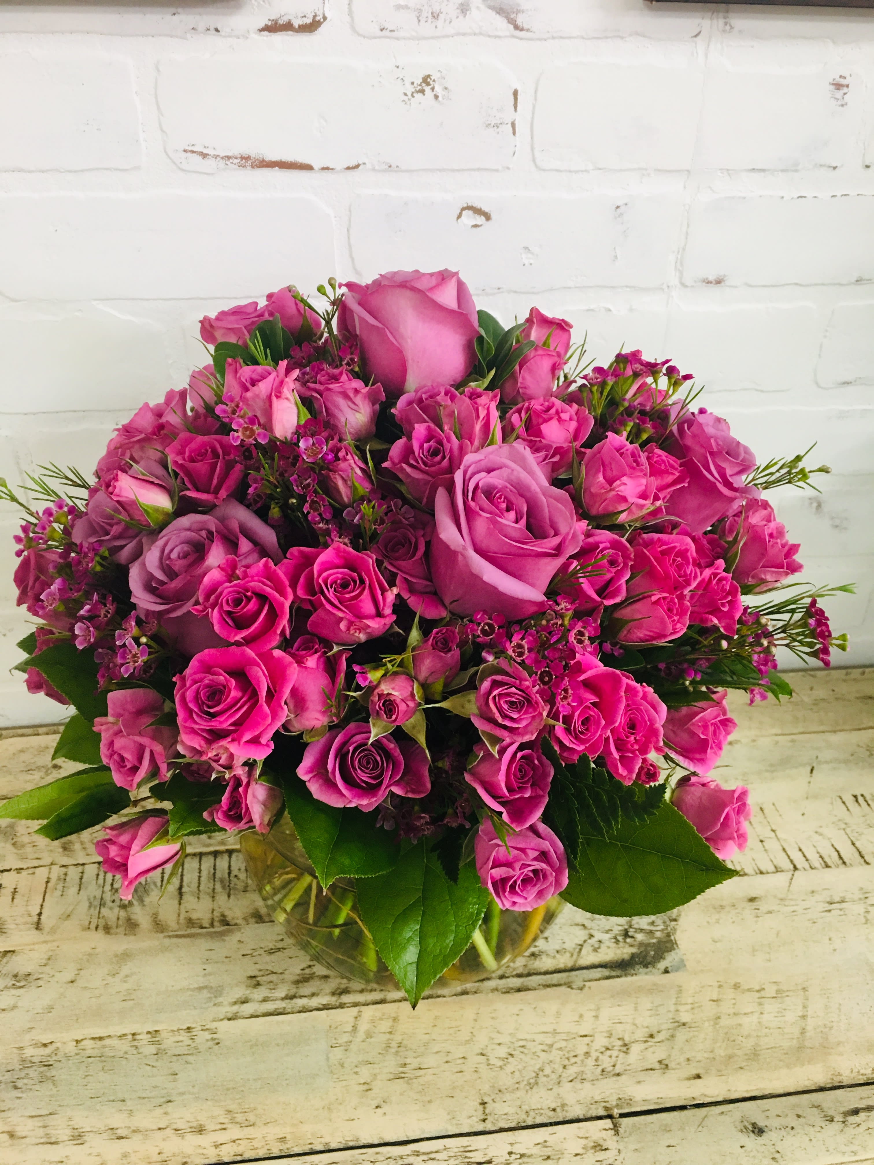 Pink and lavender rose bouquet in a glass vase