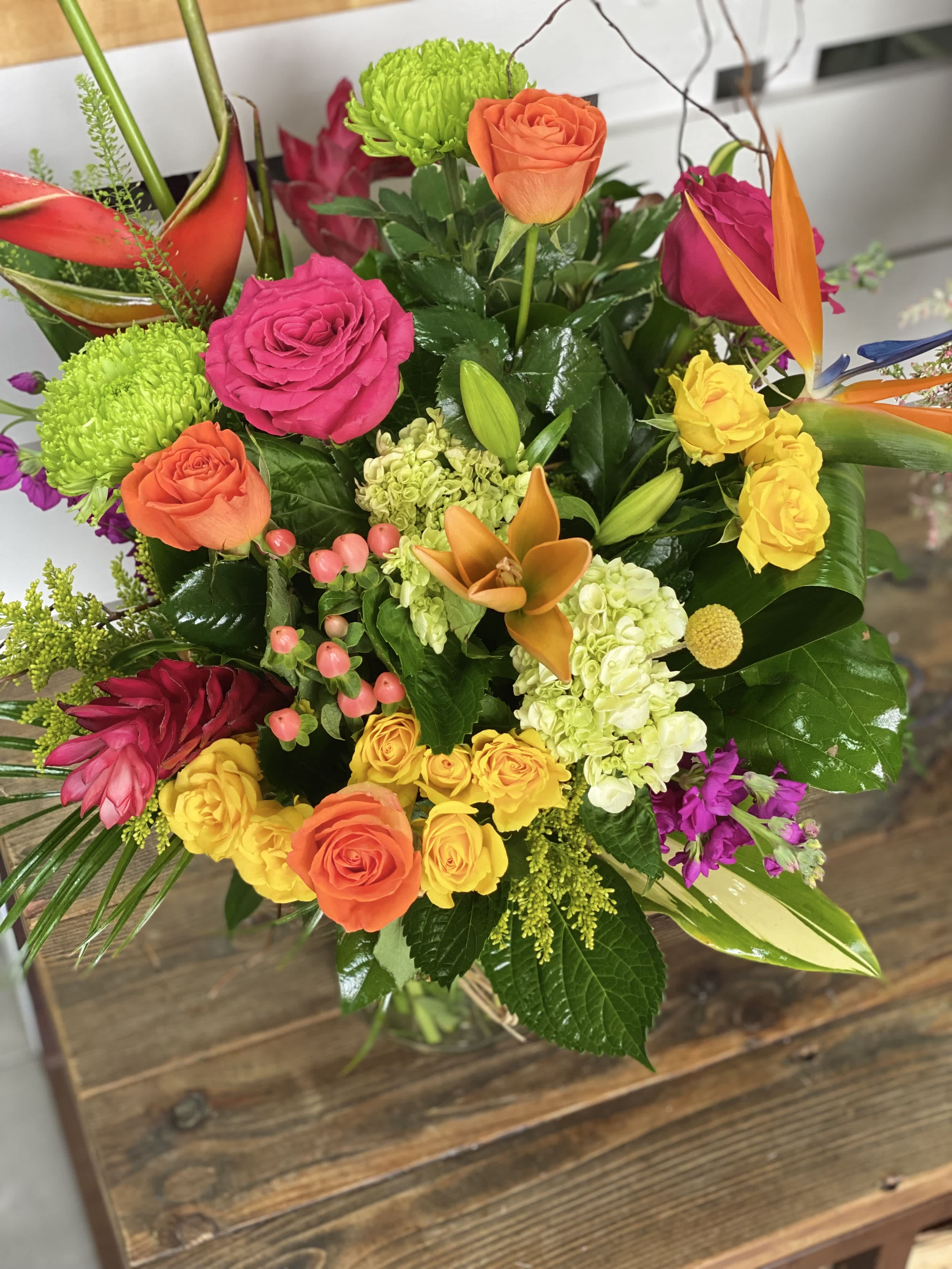Colorful mixed bouquet with roses, orchids, and green mums