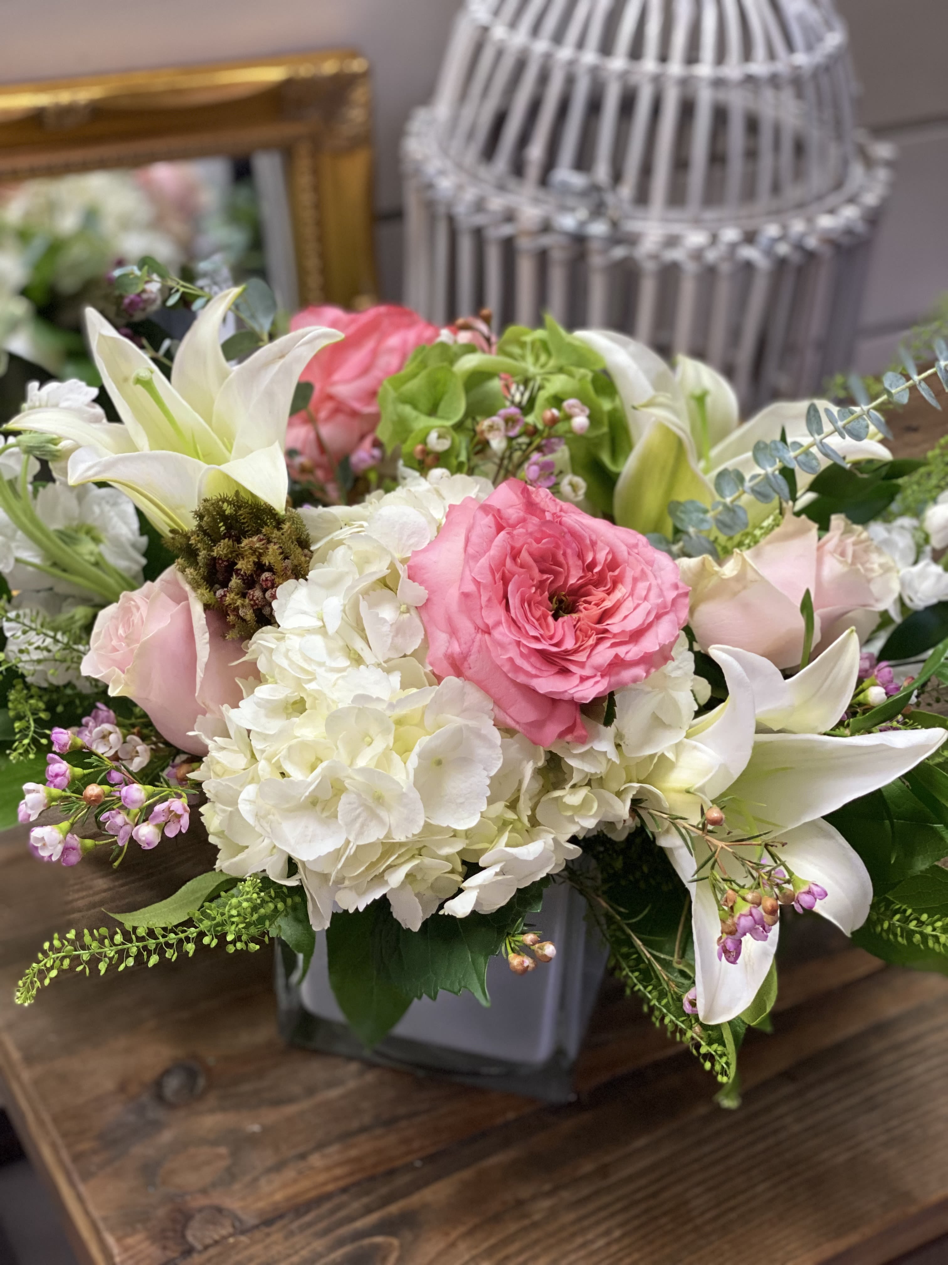 Pink and white floral arrangement in a gray vase