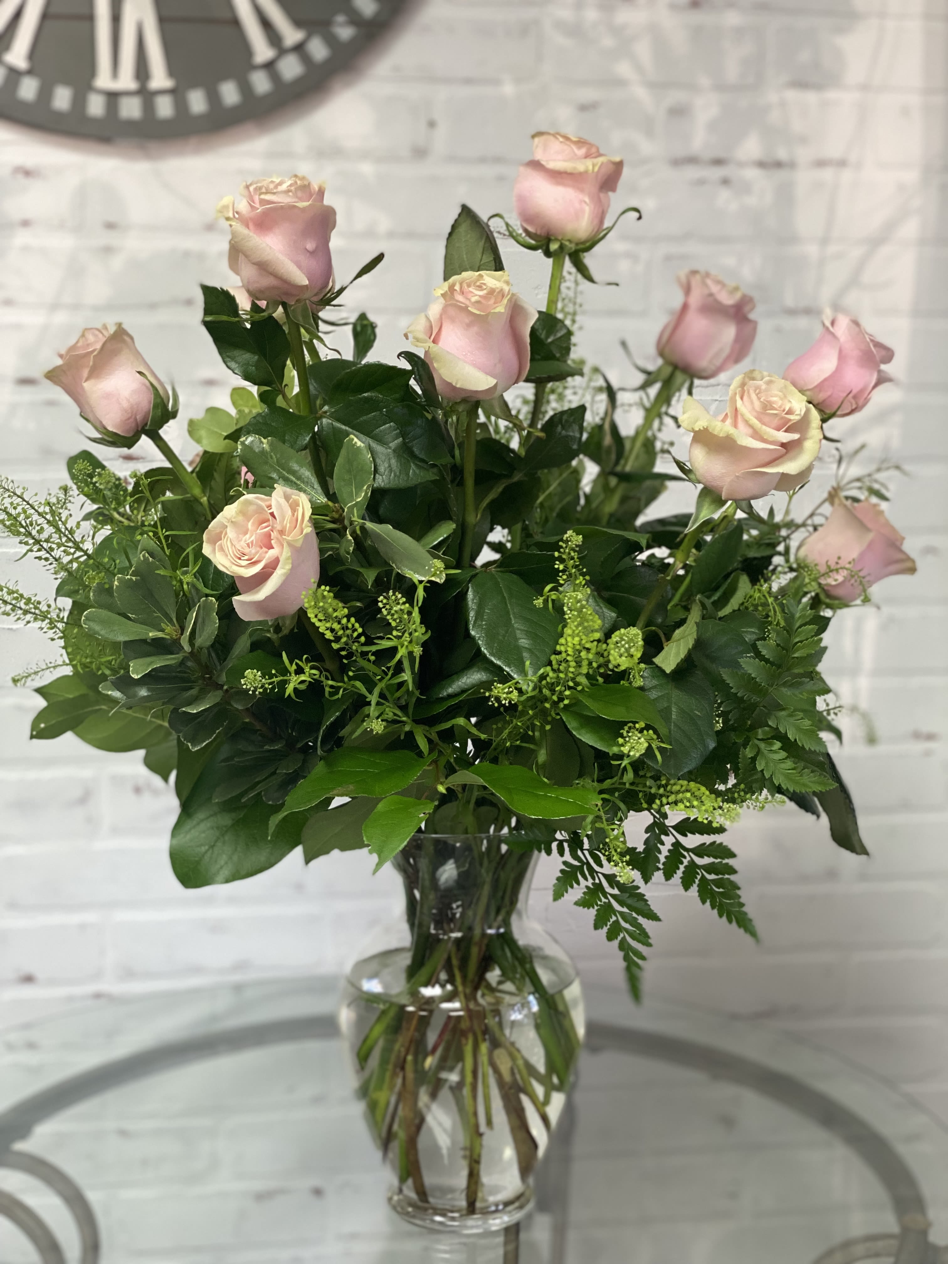 Pink roses arranged in a clear glass vase