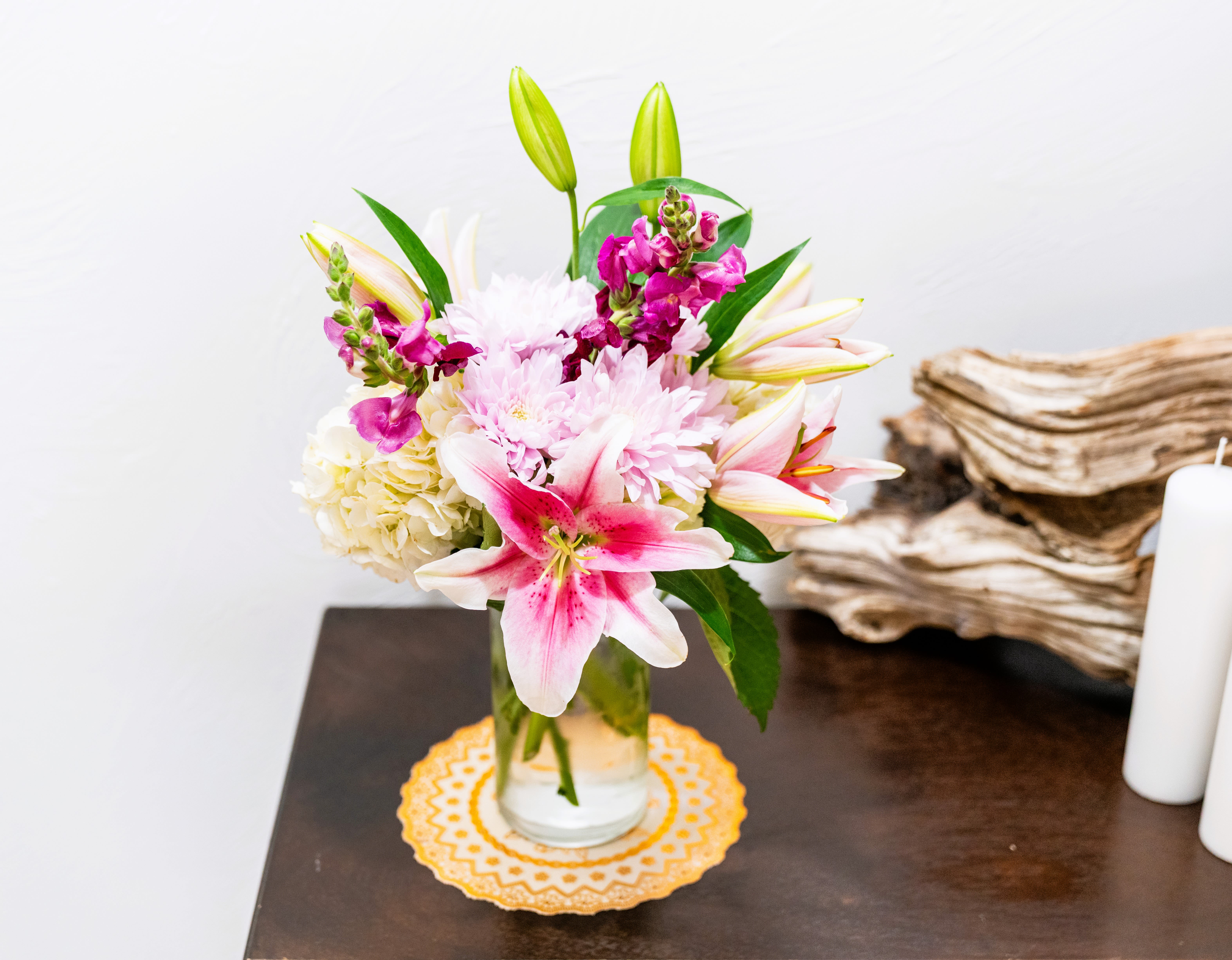 Pink lilies and chrysanthemums in a glass vase