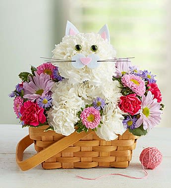 Flower basket arranged as a cat face with pink and white blooms
