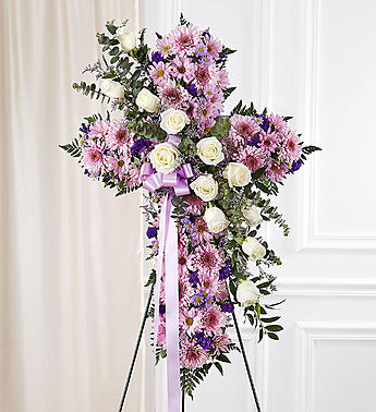 Standing floral spray of pink and white flowers with a lavender ribbon
