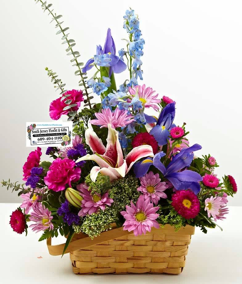 Colorful mixed flower arrangement in a woven basket