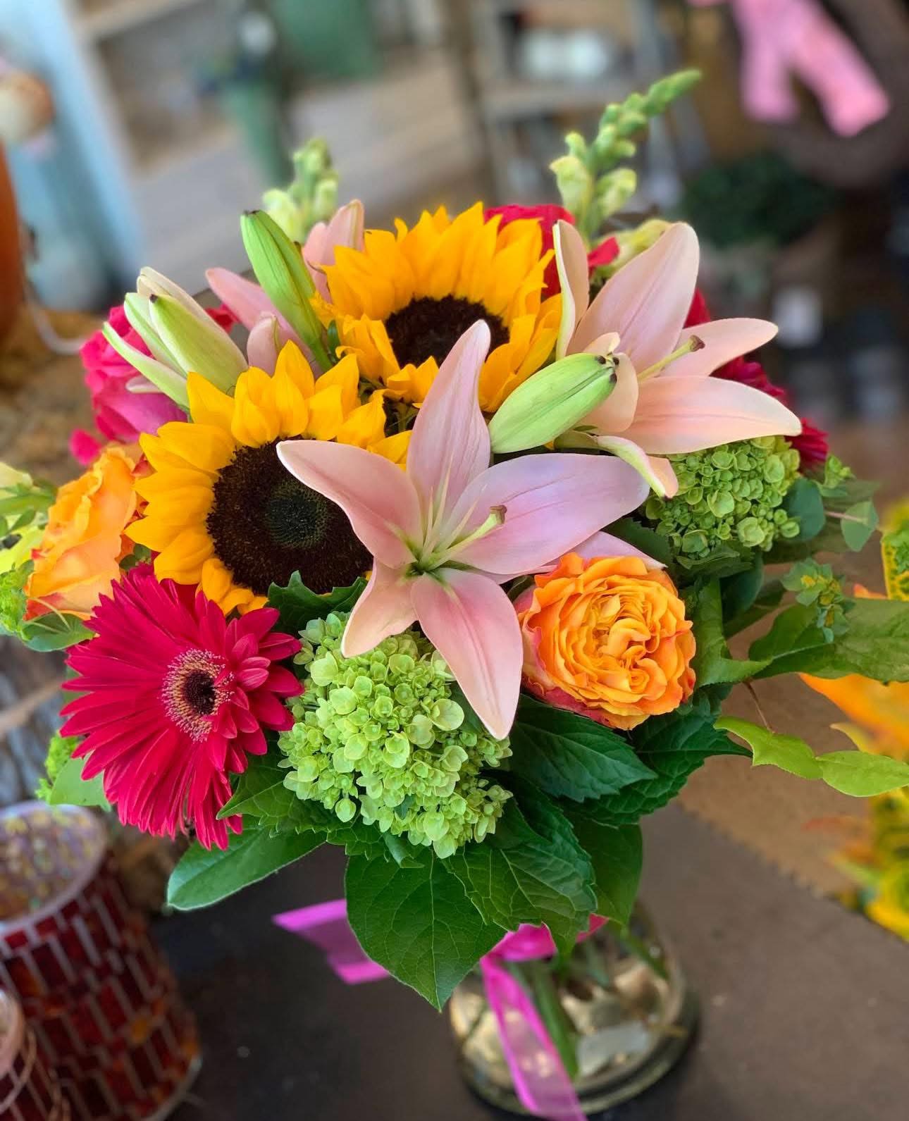 Bouquet with sunflowers, pink lilies, and orange roses