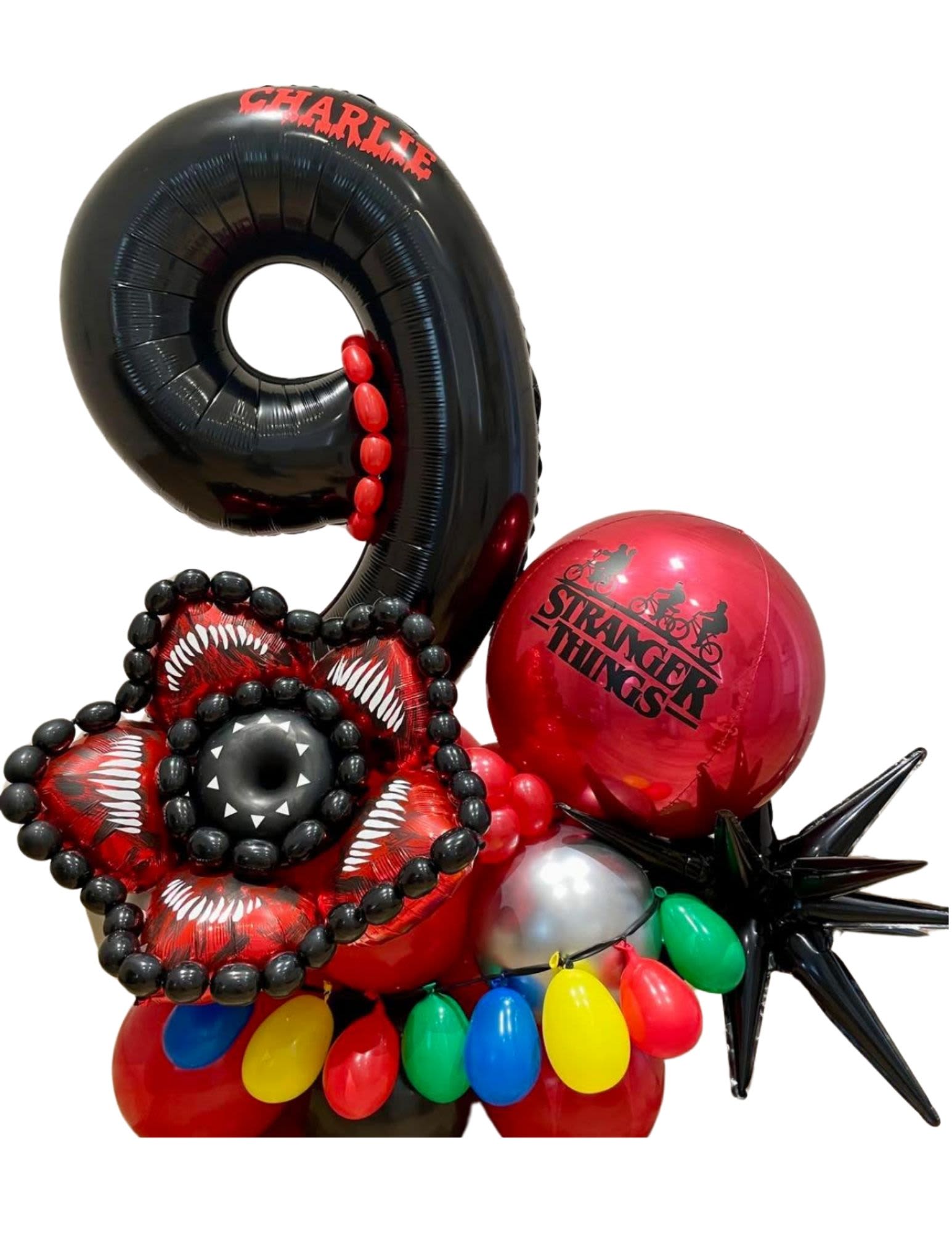 Stranger Things-themed balloon arrangement with a large black 9 and red balloons