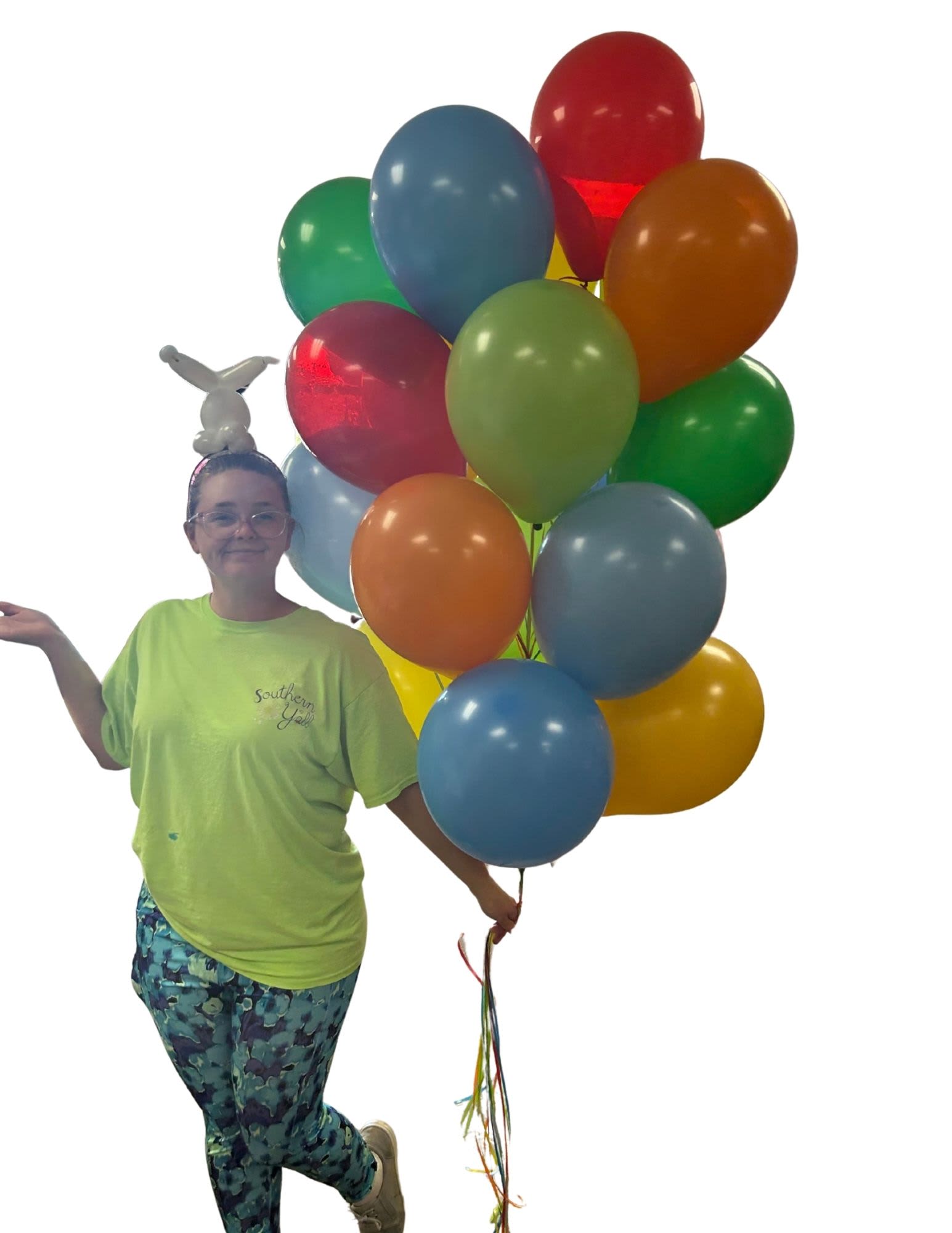 Person holding a bunch of colorful balloons with a small balloon animal on her head