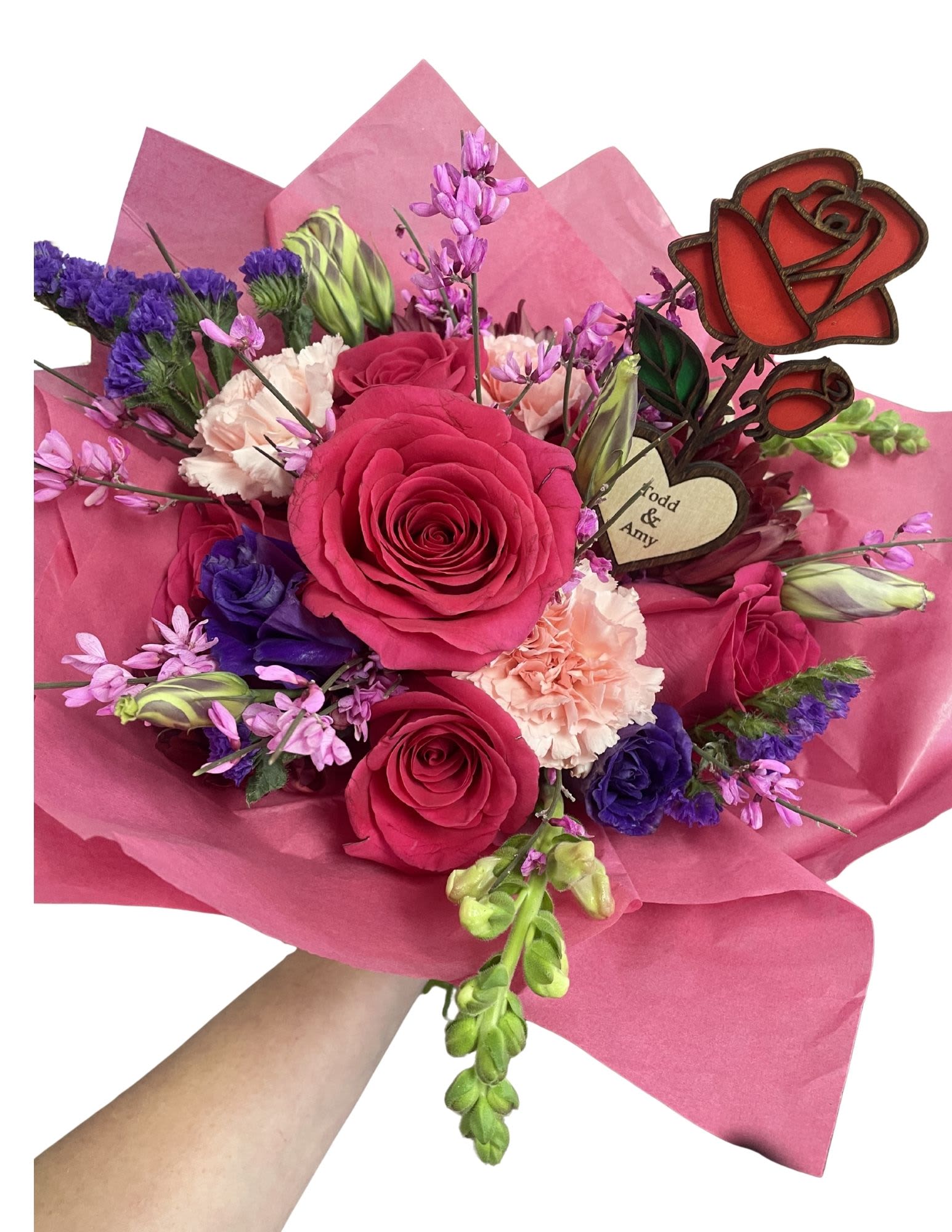 Bouquet of pink and purple flowers wrapped in pink paper