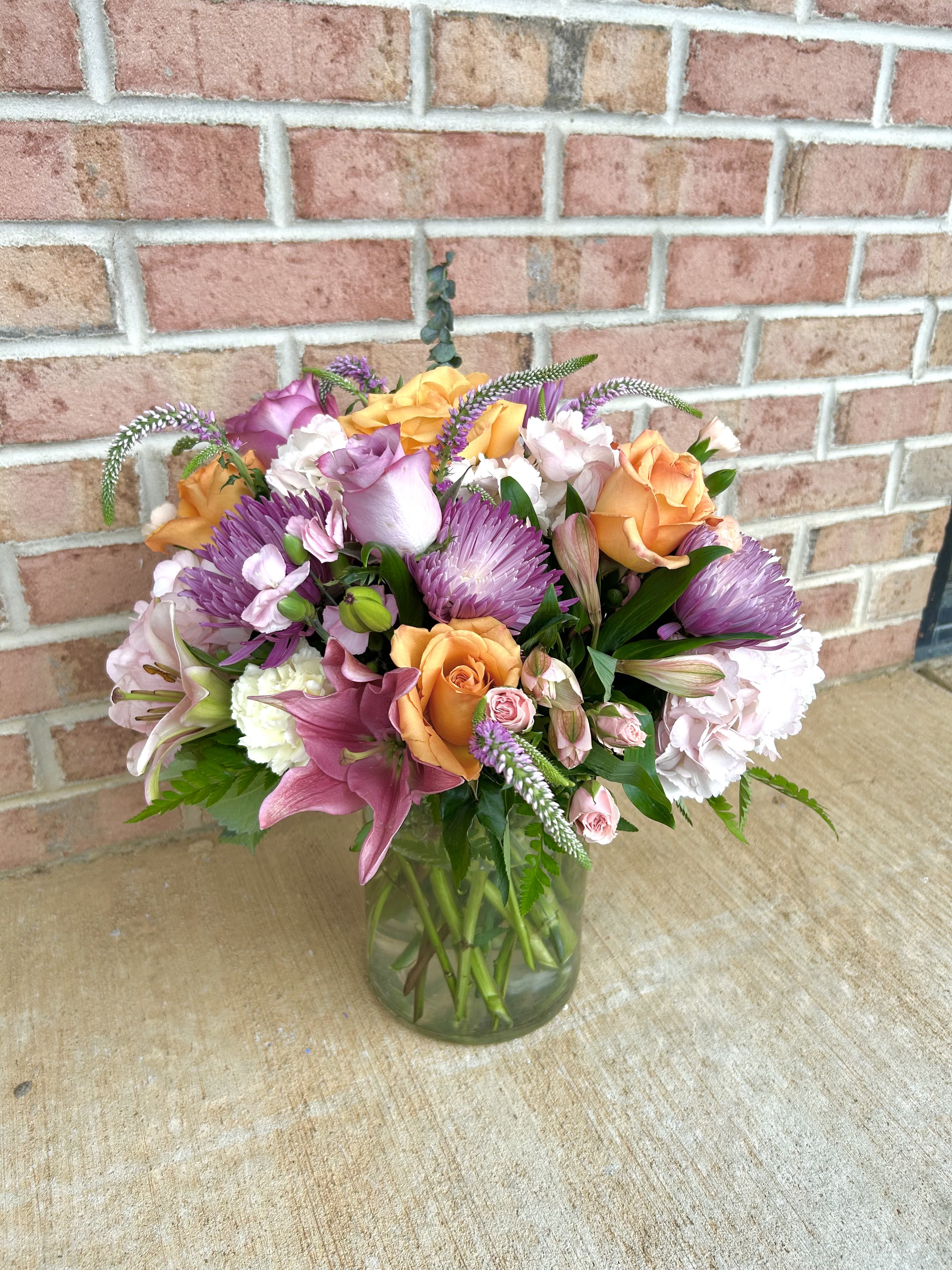Pastel sunshine  - A beautifully arranged mix of pastel florals. lavenders, soft pinks and oranges. This arrangement says it all. 