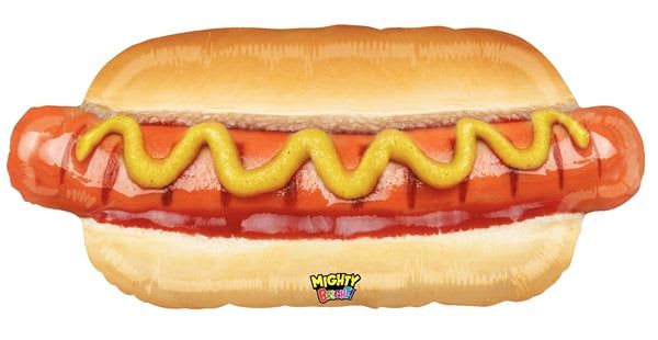 34" Jumbo Hot Dog Mylar - A playful 34" Jumbo Hot Dog Mylar balloon makes a whimsical addition to birthday parties, barbecues, or any celebration where a lighthearted touch is wanted. This novelty foil balloon-designed like a hot dog nestled in a bun with a bright yellow mustard squiggle-sends a fun, cheeky message that will make the person you're thinking of smile and spark conversation at the party.  The glossy orange, yellow, and pale bun tones create a bold, festive look that stands out in photos and beside more traditional party decor. Made of durable foil, it holds helium well for extended display and includes a small printed logo near the bottom as a mark of branding. At 34 inches across, it's large enough to be a focal point on its own or paired with other balloons and decorations for a themed tableau.  Perfect for grill‑out hosts, food‑lovers, or anyone who appreciates novelty gifts, this jumbo hot dog balloon is an easy way to celebrate with humor. For best results, have it filled with helium at the shop or follow foil balloon care-keep away from sharp edges and indoor heat sources-to enjoy its full, glossy impact through your event.