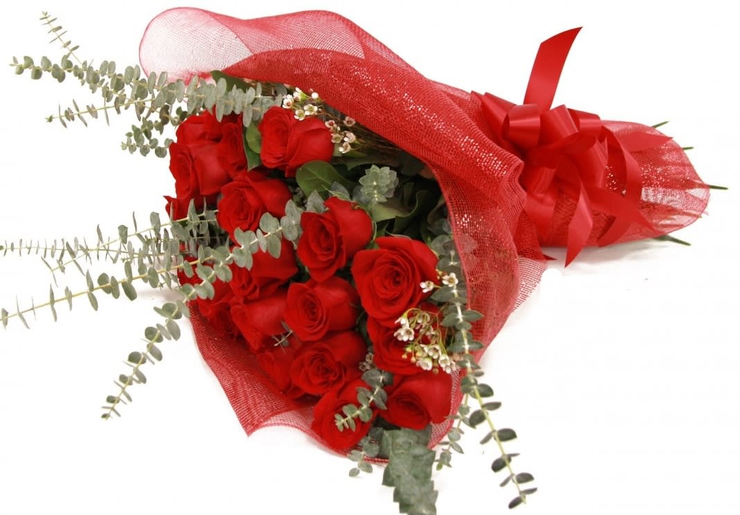 2 dozen long-stemmed red roses  - Say ‘I love you’ the traditional way with this stunning bouquet featuring  2 dozen Fairtrade red roses.This premium arrangement is enhanced with a beautiful backdrop of   eucalyptus to make the vivid red pop - perfect for a romantic gesture your loved one will remember.
