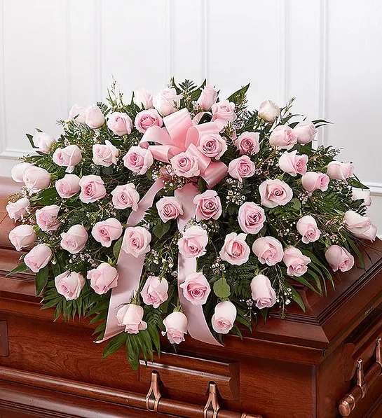 Pink Rose Half Casket Cover - The ultimate symbol of grace, love and admiration, soft pink roses are a sentimental way to honor someone who was deeply cherished. Our half casket cover, crafted with care and artistry by our expert florists with over 50 of these soft-hued blooms and accented with a pink satin ribbon, is an unforgettable way to commemorate a lifetime of unconditional love