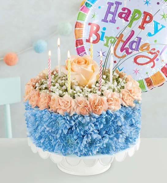 Birthday Wishes Flower Cake Coastal - EXCLUSIVE Here’s a birthday favorite that really takes the cake! Our one-of-a-kind flower creation is handcrafted from cool, coastal-colored blooms for a fun, summery gift