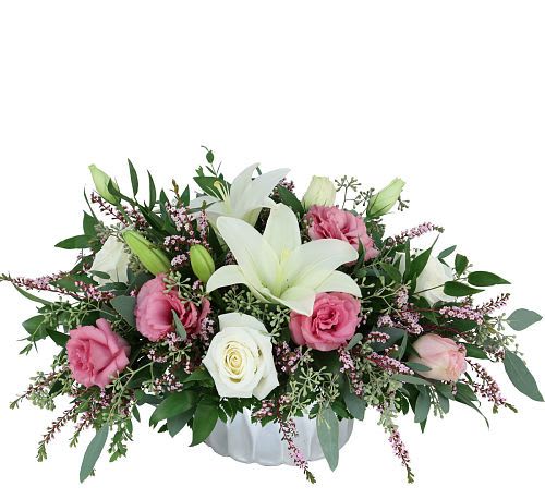 Centerpiece  - Send her a little touch of  nature’s artistry to the table with this dreamy centerpiece. featuring white lilies, pink lisianthus, and delicate pink flowers. What a showstopper!.